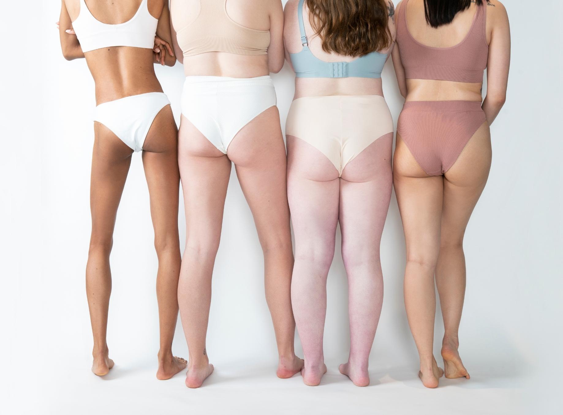 Four women in white underwear photographed from behind