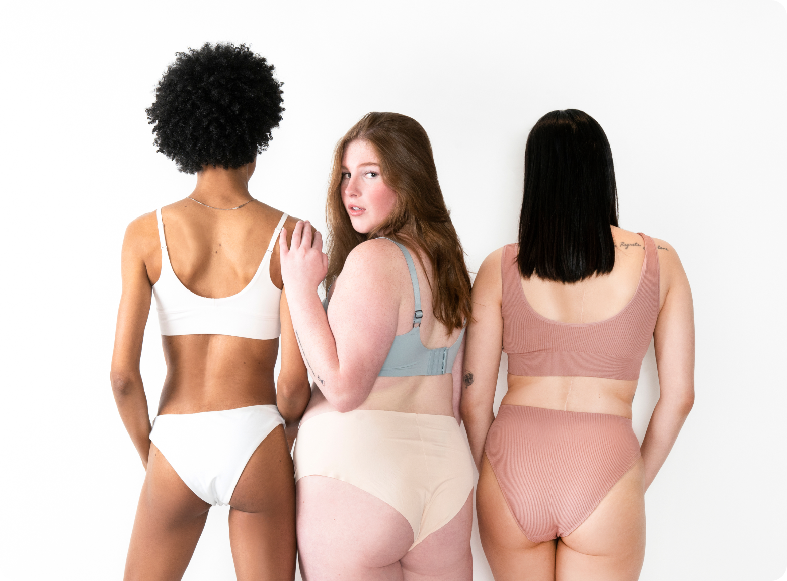 Three women standing together in underwear