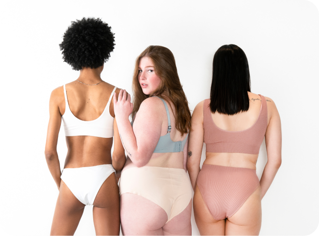 Three women standing together in underwear